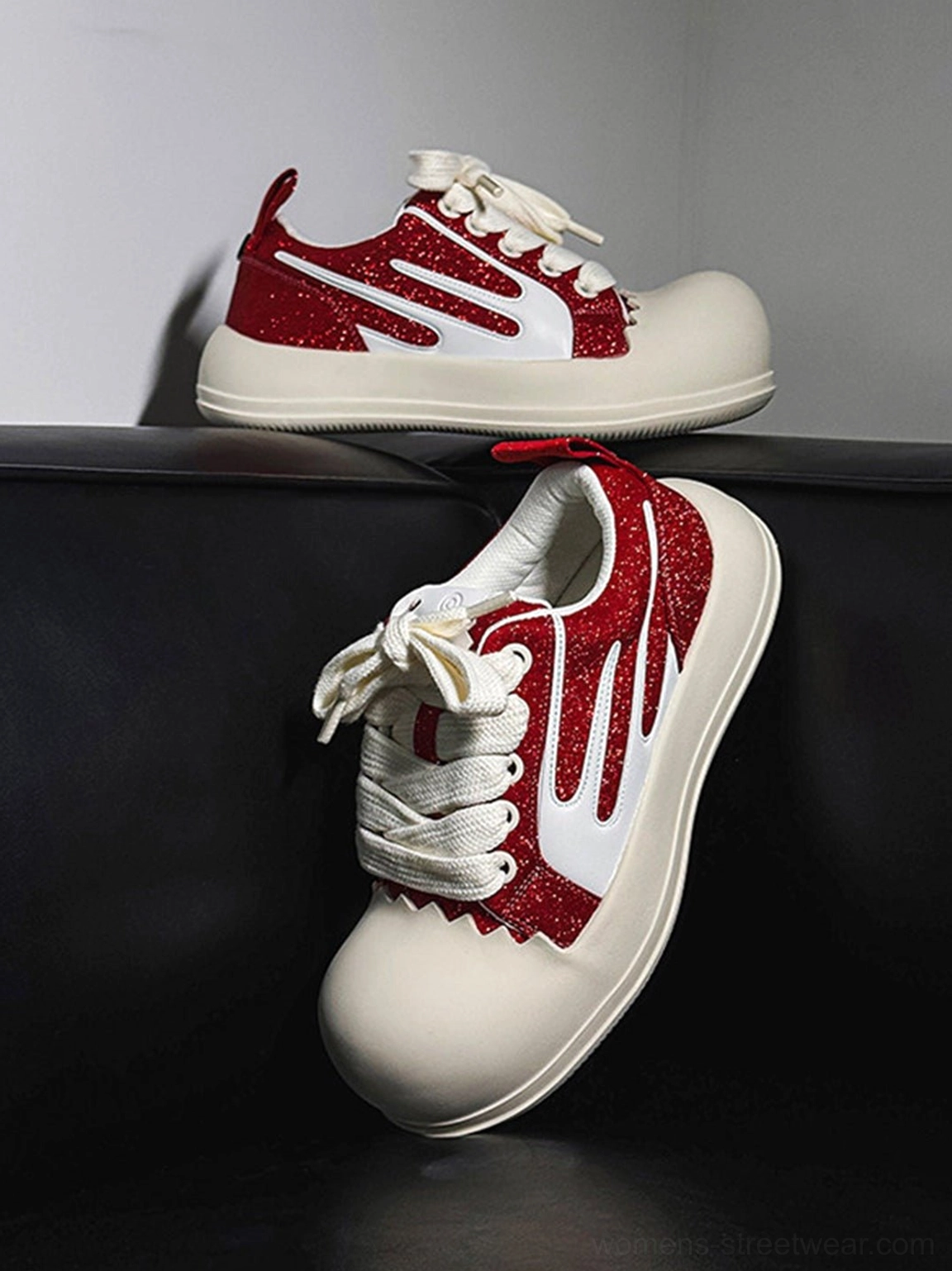 Red glitter chunky platform sneakers with oversized white rubber toe caps, white side stripes, flat laces and thick streetwear sole