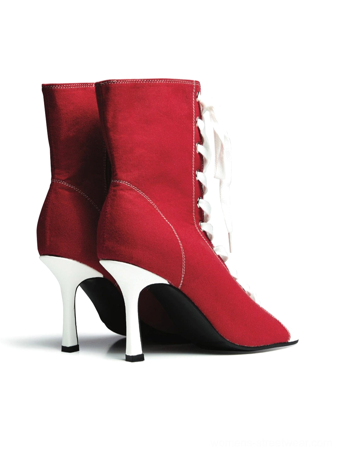 Pair of red canvas lace-up peep-toe stiletto ankle boots displayed from the back side with white contrast stitching and slim heels