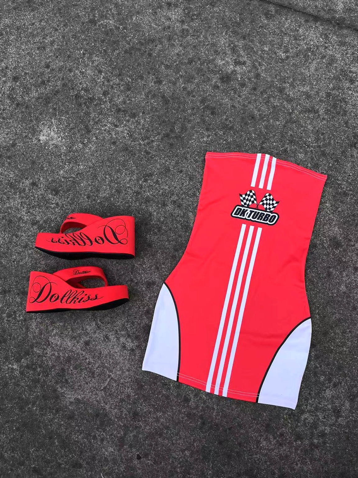 Red logo print platform wedge flip-flop design displayed in a miniature flat lay with sporty graphic tank top