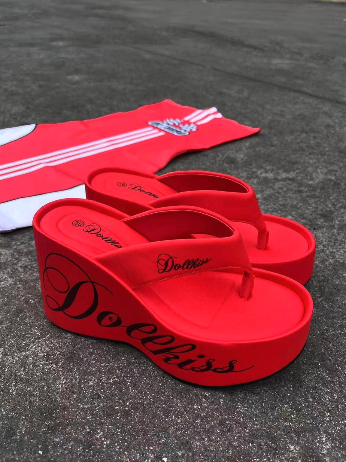 Red logo print platform wedge flip-flops displayed with a sporty red and white color block top