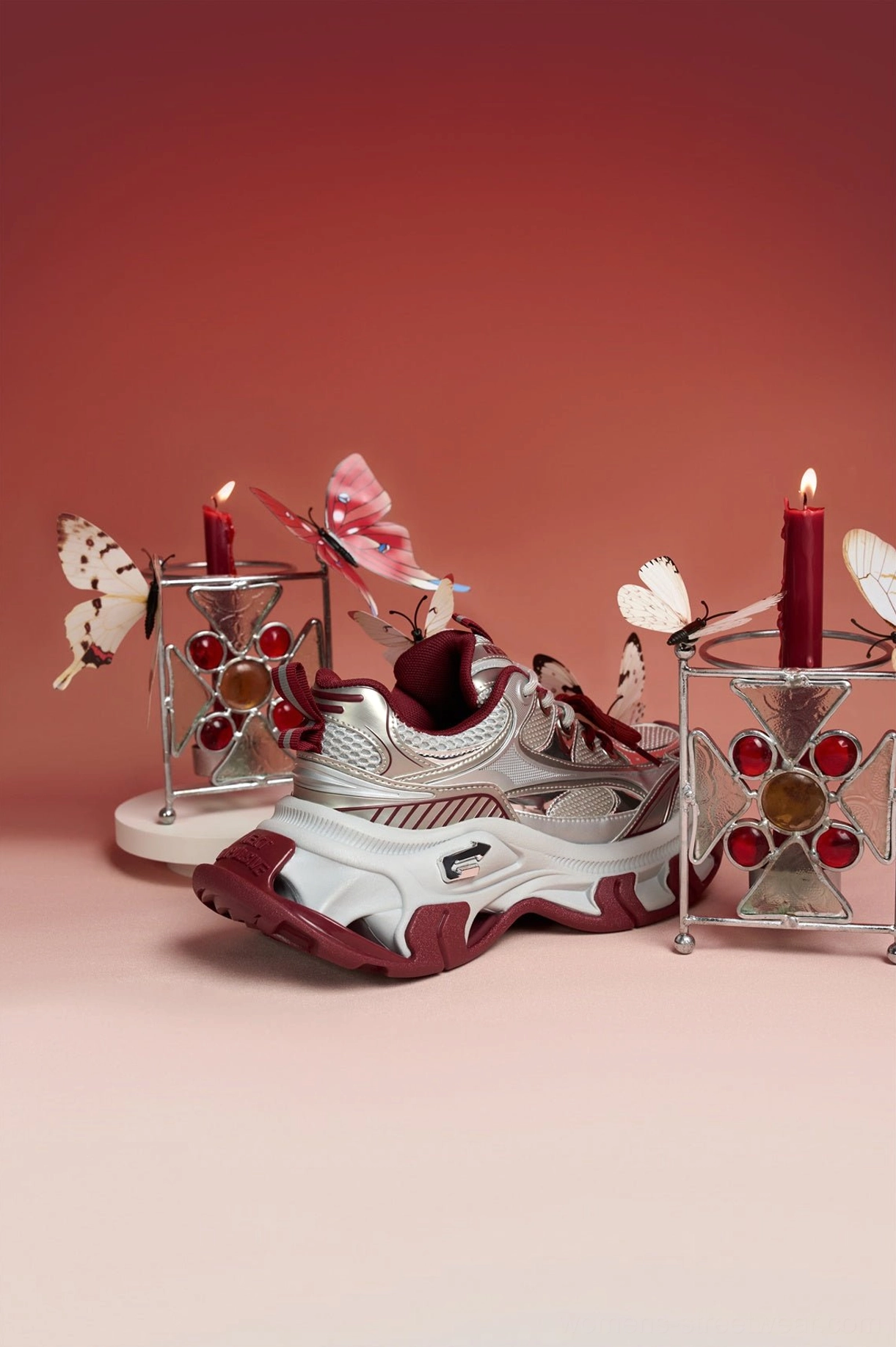 Side profile of red and silver Papillon platform sneakers emphasizing the elevated platform sole and sculptural chunky sneaker shape