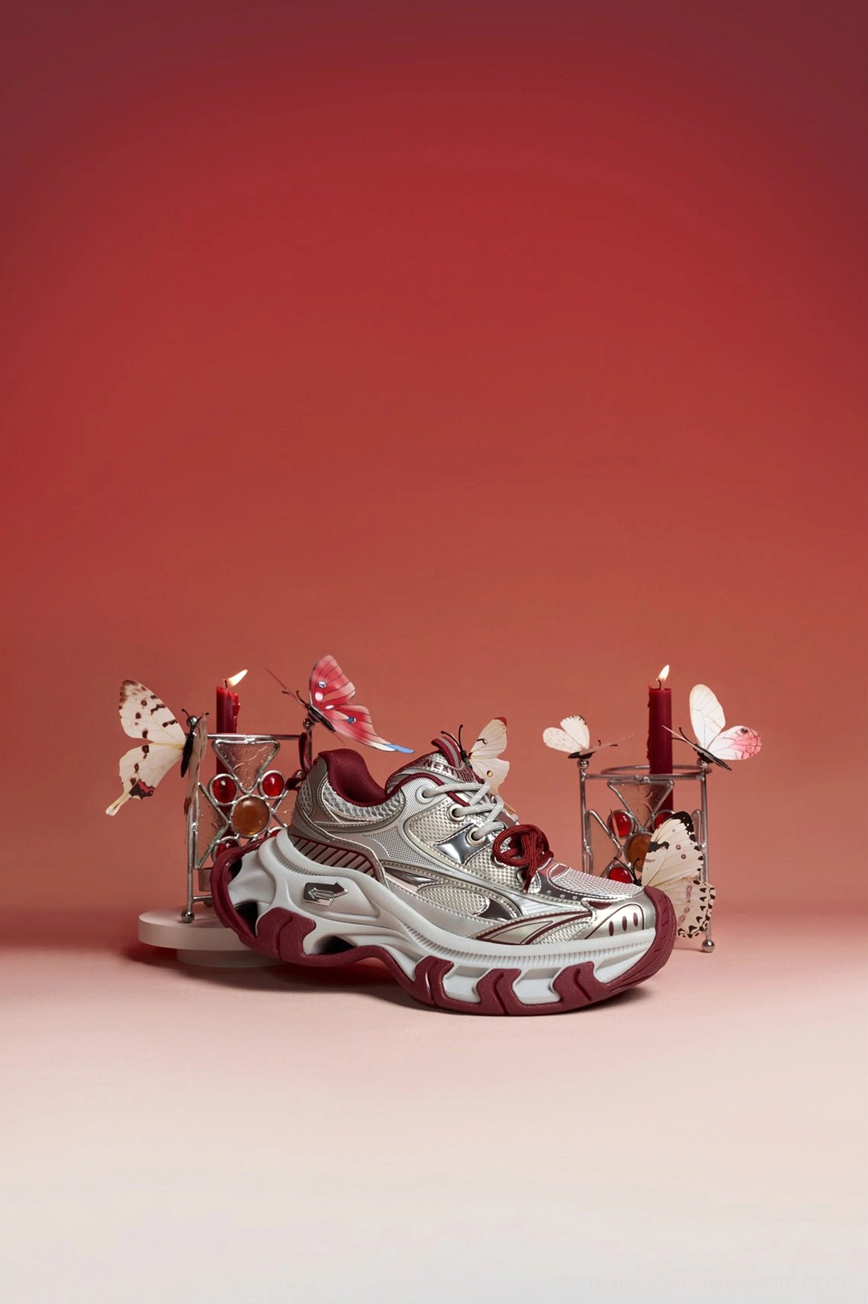 Elevated side view of silver and burgundy platform sneakers highlighting the structured toe cap and textured leather-look upper