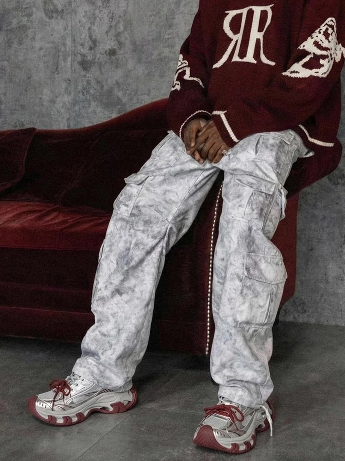 Red and silver chunky platform sneakers paired with white tie-dye cargo pants in an edgy Y2K streetwear outfit