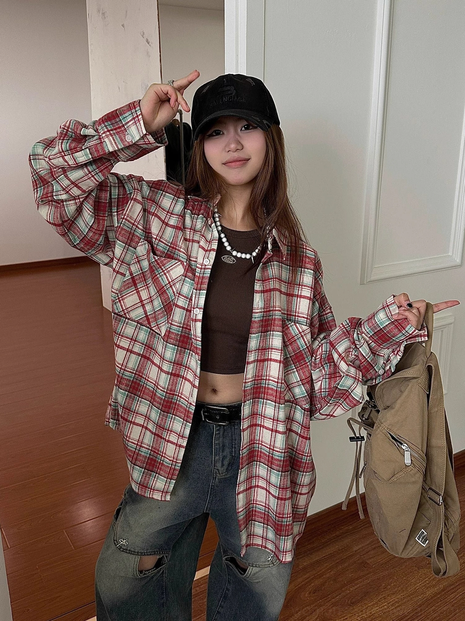 Red plaid oversized flannel shirt for women styled as a versatile casual streetwear layer