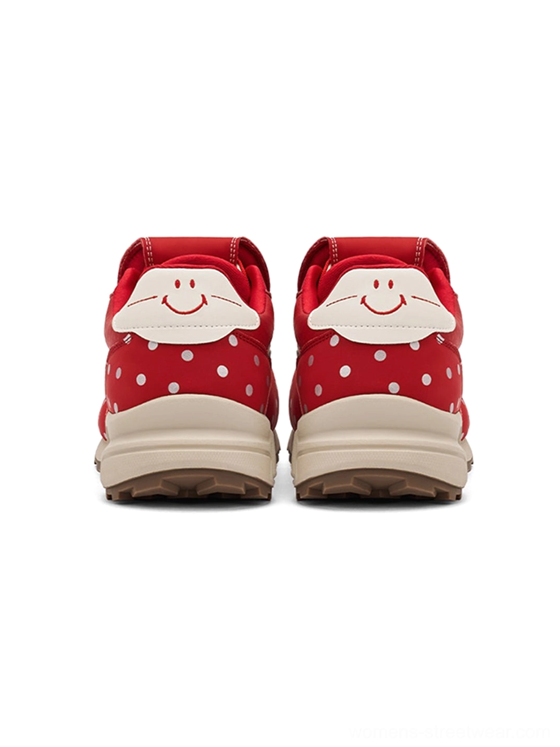 Rear view of red polka dot platform sneakers with smiling face heel graphic and contrast outsole