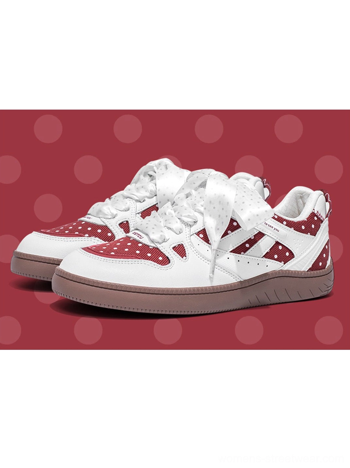 Red polka dot ribbon low top skate sneakers with oversized laces and a bold streetwear-inspired silhouette