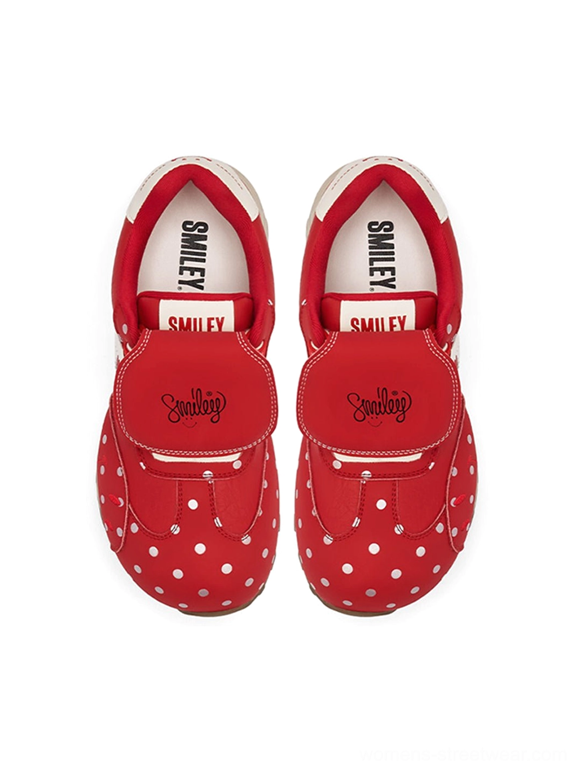 Top down view of red polka dot sneakers showing the smiley printed insole and adjustable strap embroidery