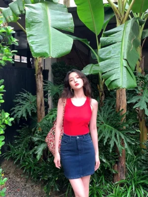 Red retro ribbed slim-fit tank top for women styled in a tropical outdoor streetwear setting