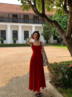 Front view of a bright red retro square neck sleeveless maxi dress with wide shoulder straps, fitted waist, and flowing floor length A line skirt