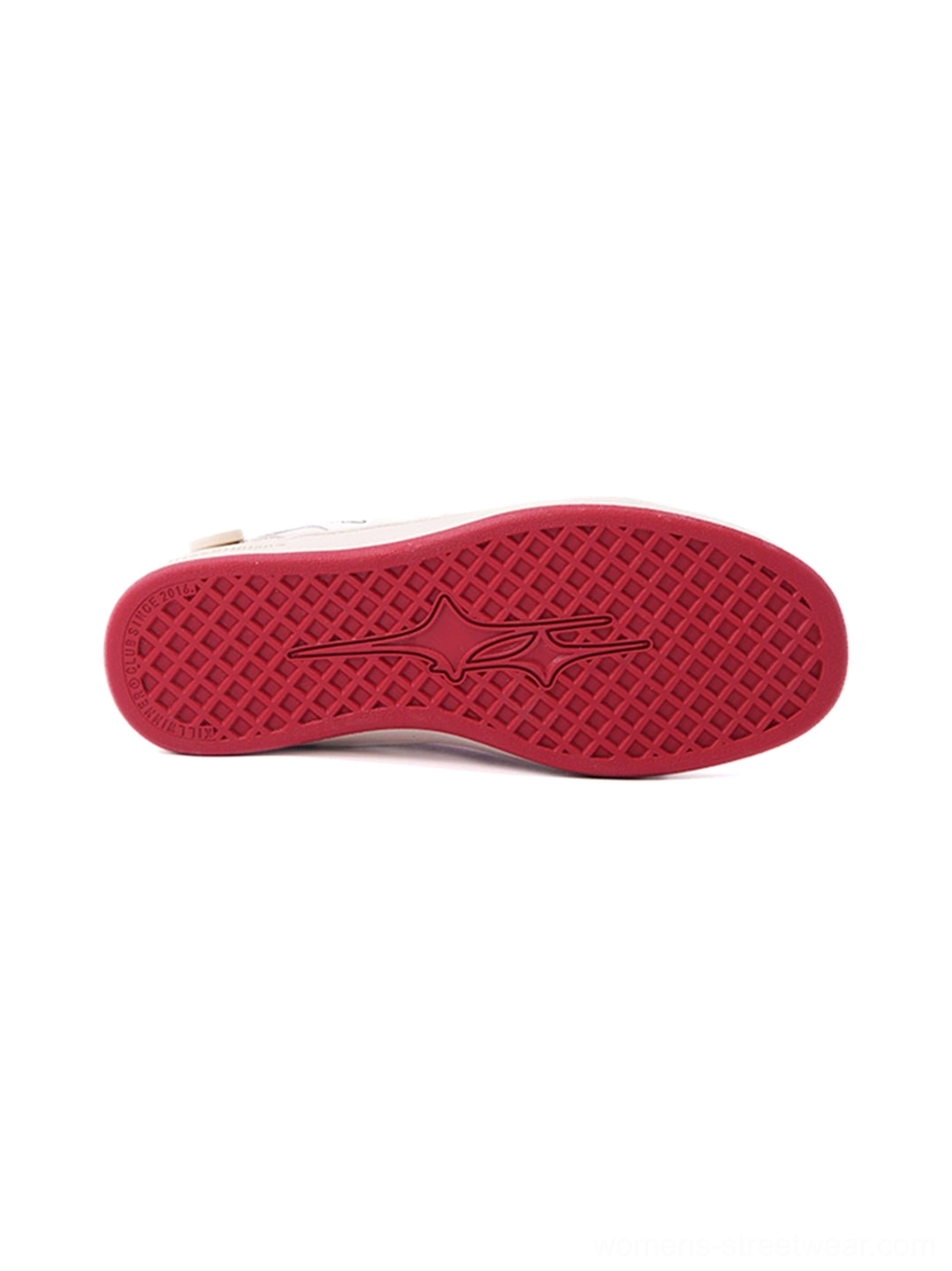 Bright red rubber outsole of a retro training sneaker featuring an embossed flame-shaped anti-slip tread pattern