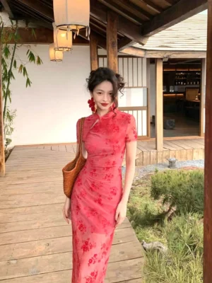 Red sheer floral cheongsam-inspired maxi dress with stand collar keyhole neckline short sleeves and floor-length bodycon silhouette