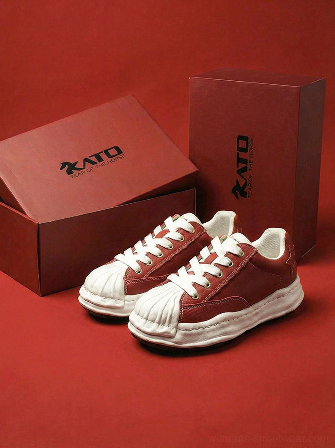 Red shell-toe court sneakers shown in a clean studio display with bright white sole and contrast details