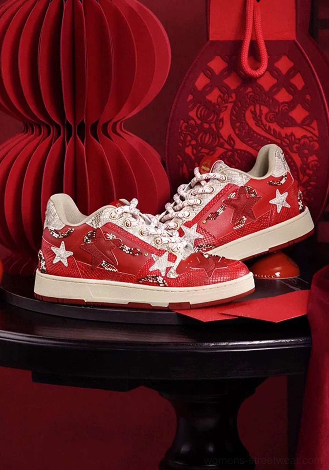 Red snake-embossed star court sneakers displayed with Chinese New Year lanterns and dragon-inspired festive decor