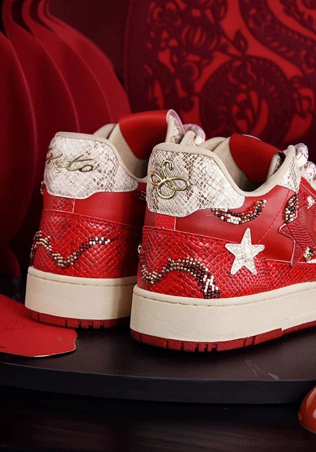 Rear view of red snake-embossed star court sneakers showing textured heel panels, white stars, and off-white outsole