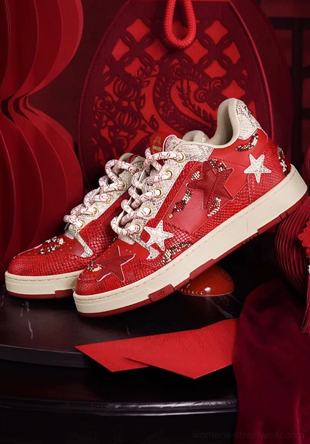 Side profile of red snake-embossed star court sneakers with white star appliques and off-white red-trimmed sole