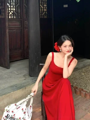 Side angle view of a red square neck maxi dress with slim fitted bodice, heavy draped skirt, and vintage streetwear styling