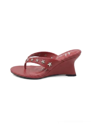 Red thong kitten-heel sandals with silver star studs, softly squared open toe, and low curved heel shown from the side
