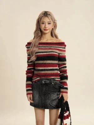 Close front view of red striped off-shoulder fuzzy knit sweater with a high-waisted black denim skirt and statement belt