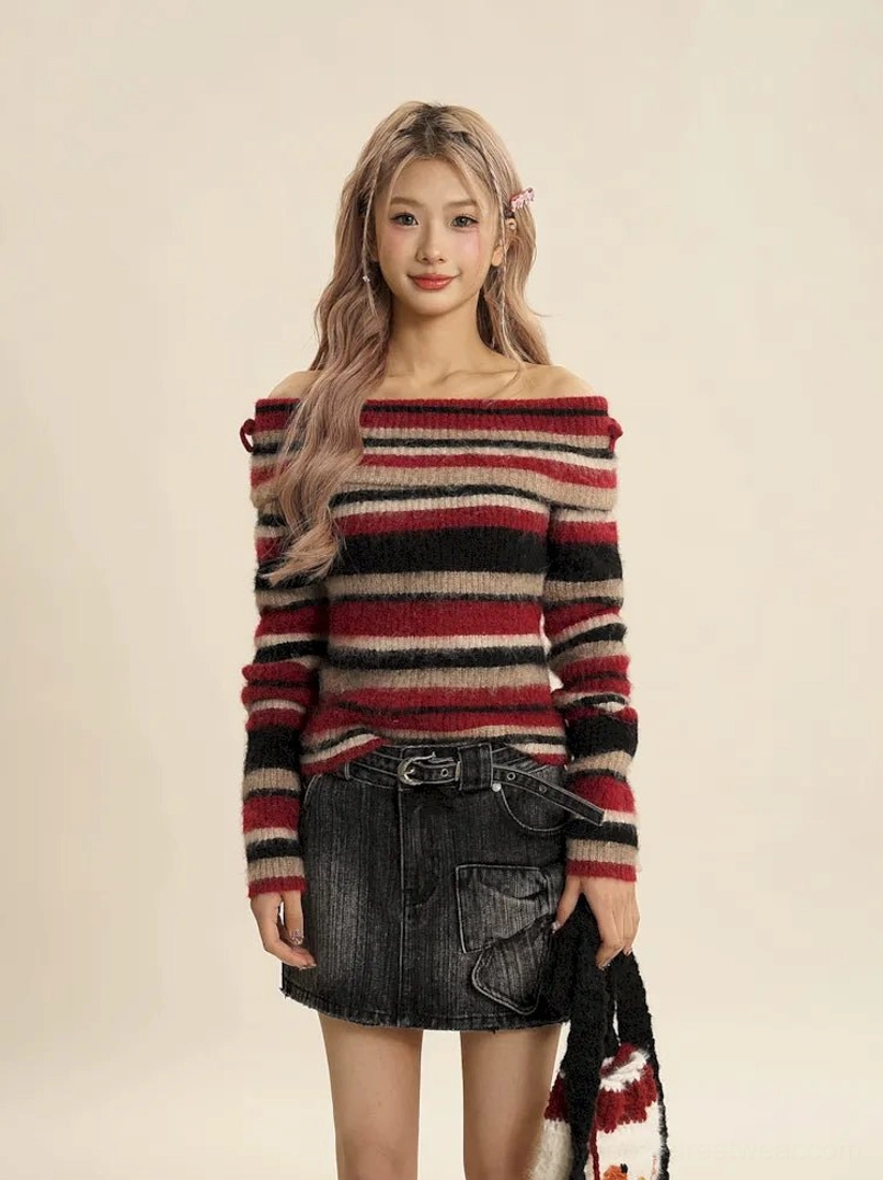 Close front view of red striped off-shoulder fuzzy knit sweater with a high-waisted black denim skirt and statement belt