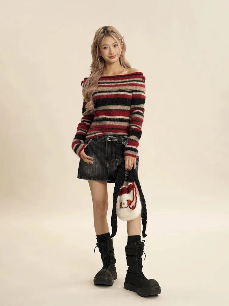 Three-quarter front view of red striped off-shoulder fuzzy knit sweater styled with a black mini skirt for Y2K streetwear