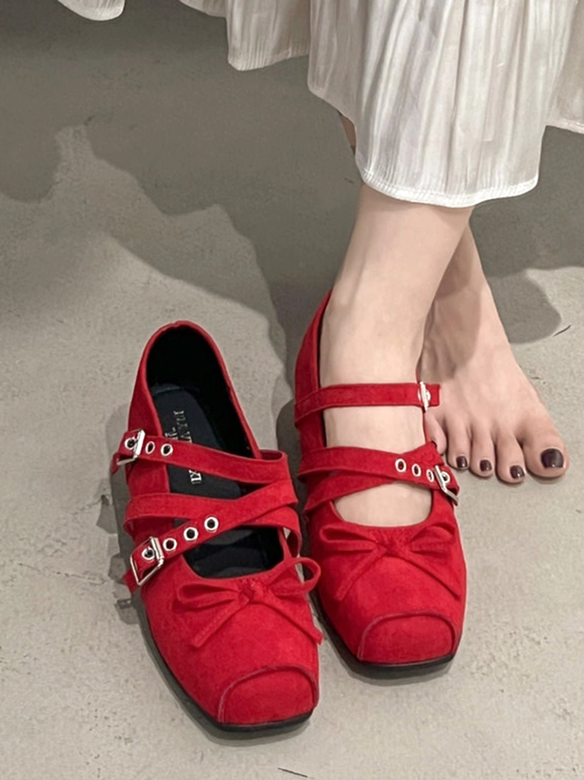 Red suede square-toe Mary Jane flat styled with a white pleated midi skirt for a Korean streetwear look