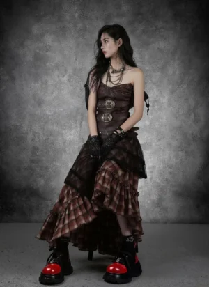 Women's black and red platform derby shoes styled with a gothic steampunk streetwear outfit on a model in a dark studio setting