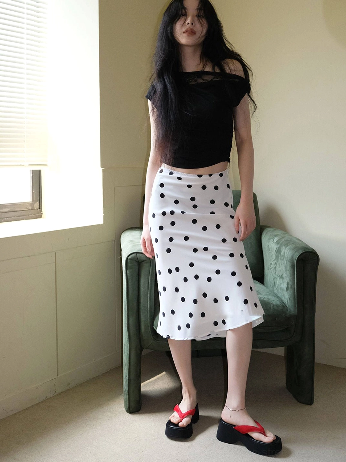 Full-length streetwear outfit featuring red toe strap black platform flip-flops and polka dot midi skirt