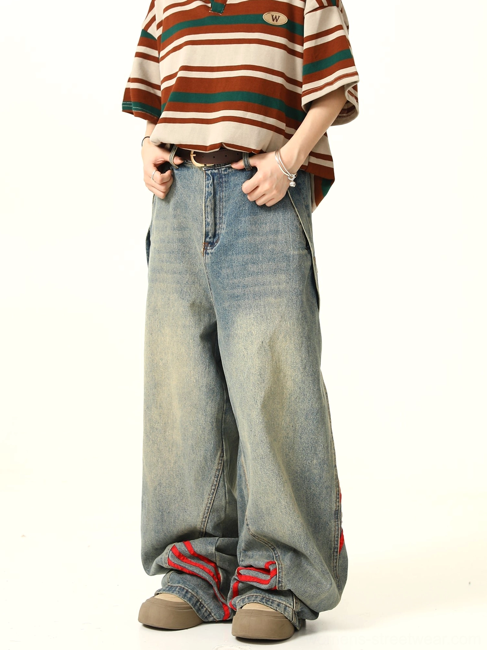 Waist-to-foot view of relaxed wide-leg blue denim jeans with red stripe details, zipper fly, belt loops, and vintage wash