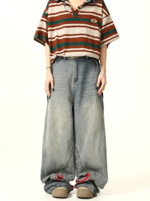 Front full-body view of light blue wide-leg denim jeans with bold red triple stripes and vintage faded streetwear wash