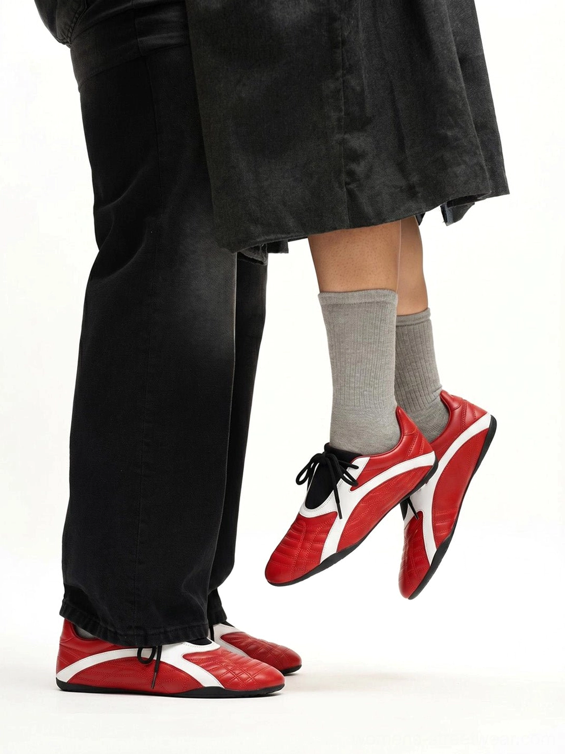Two models wearing red and white quilted flat sole sneakers with casual daily streetwear outfits and visible side stripe details