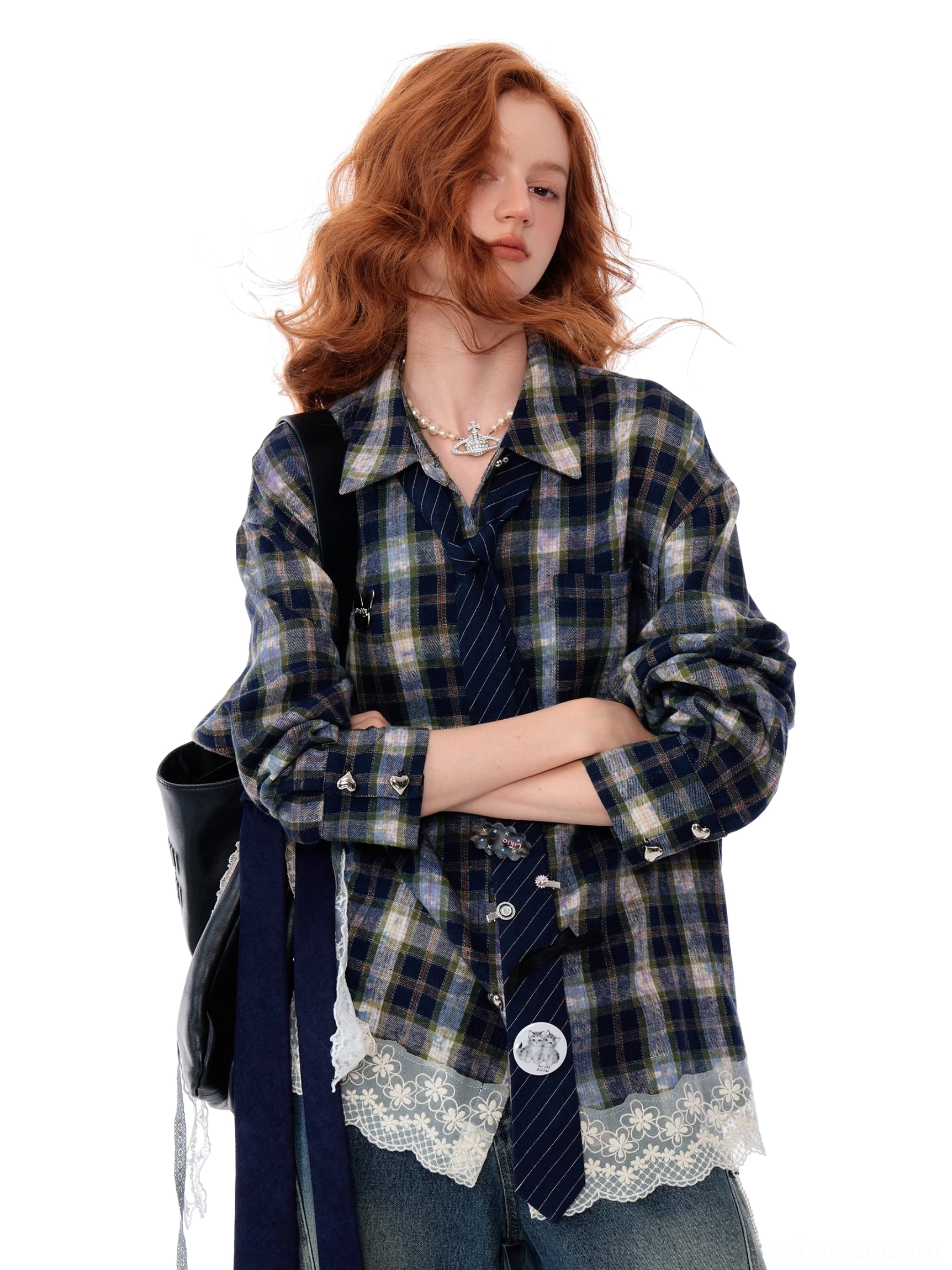 Three-quarter view of a relaxed blue plaid button-up shirt with lace trim hem, long tie ribbons, and rolled cuffs
