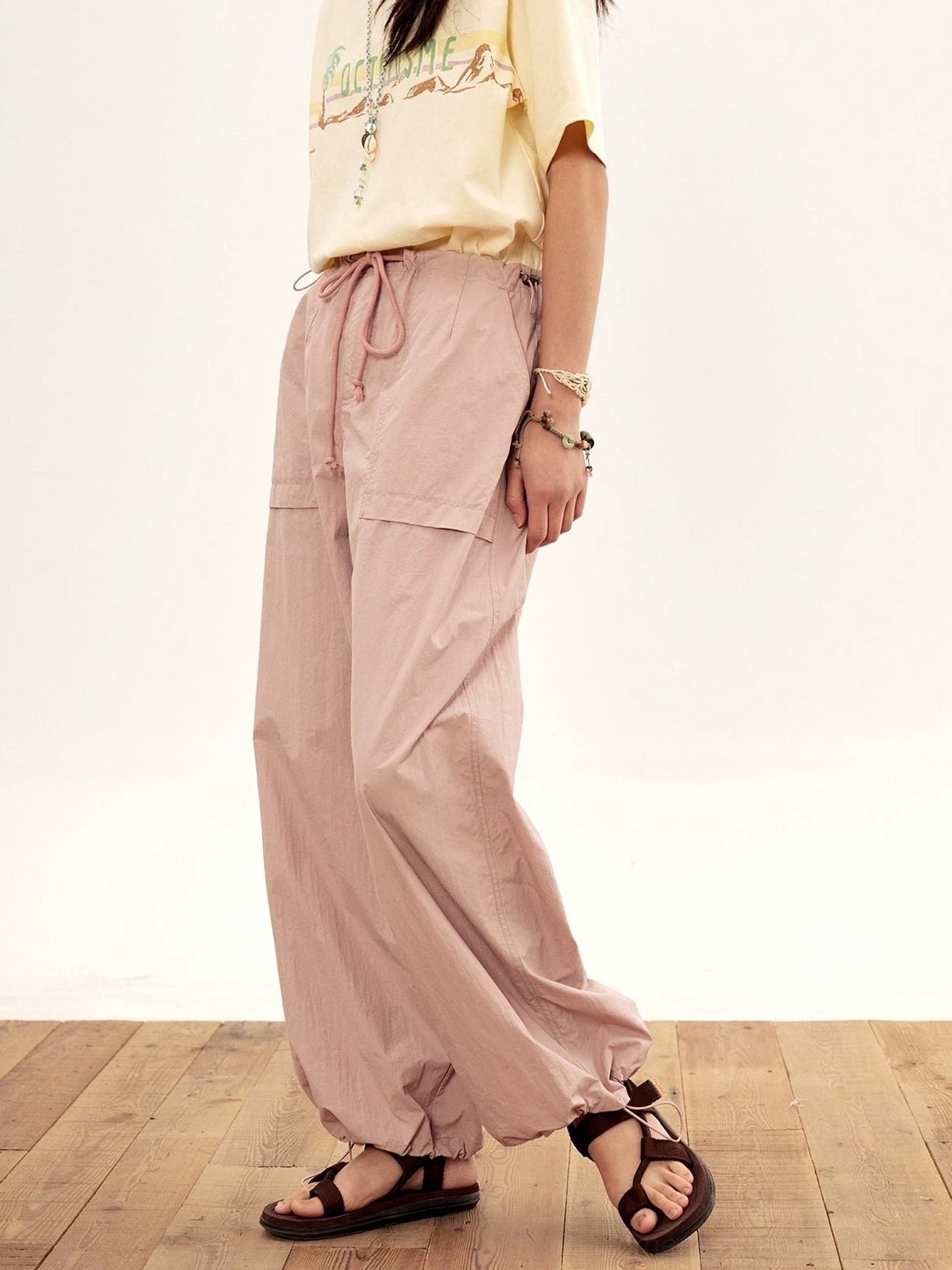relaxed nylon cargo pants dusty pink full-body static standing front view leather sandals