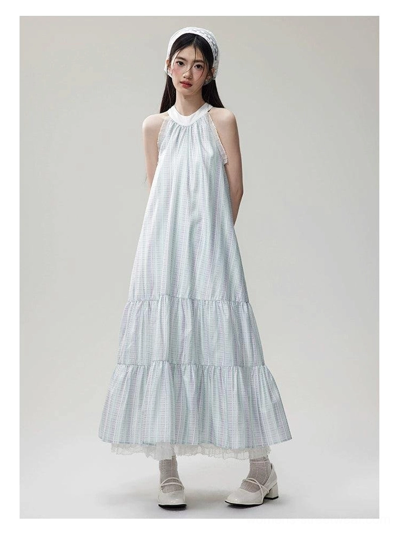 Side front view of a relaxed checkered tiered maxi dress with halter neckline, lightweight organza fabric, ruffled skirt, and delicate lace hem