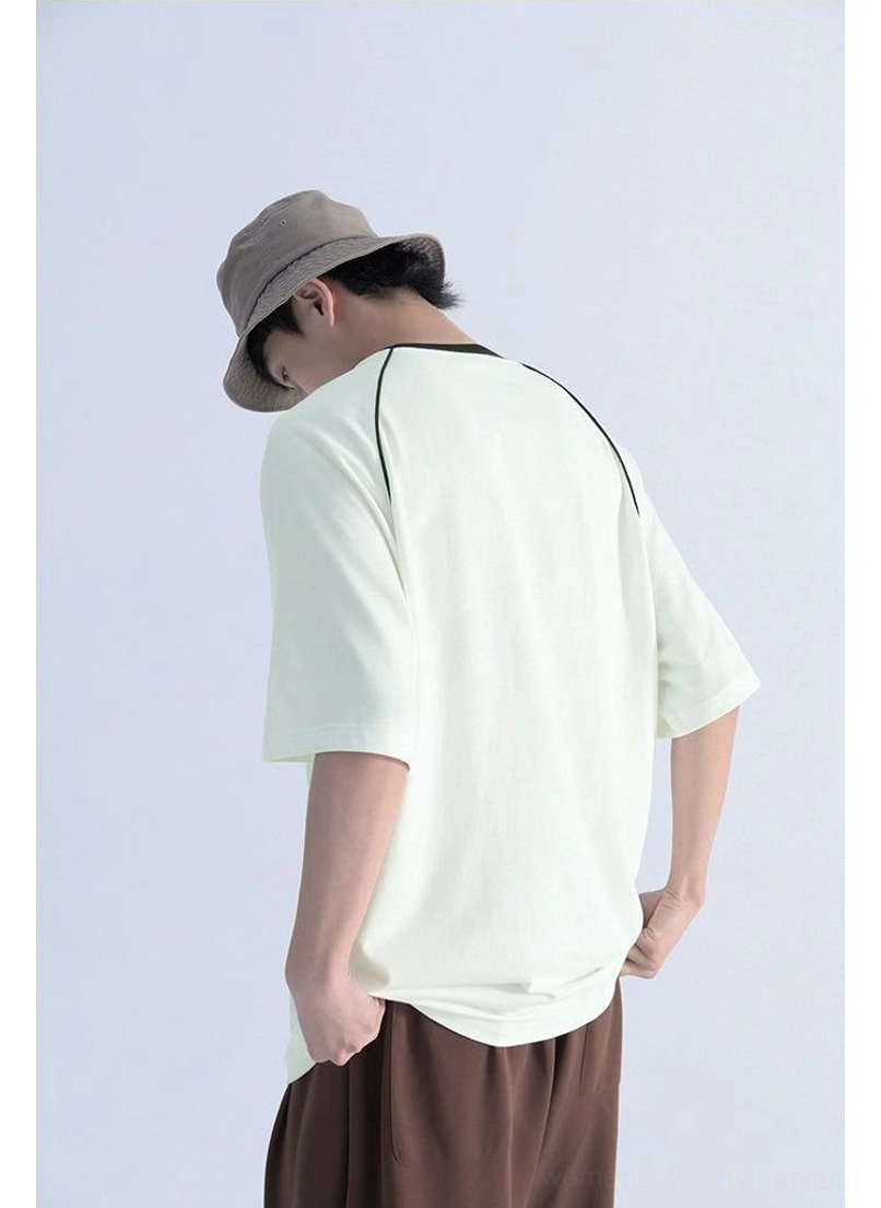 Back three-quarter view of relaxed contrast raglan sleeve T-shirt showing oversized fit, clean solid body, and detailed rear shoulder seam construction