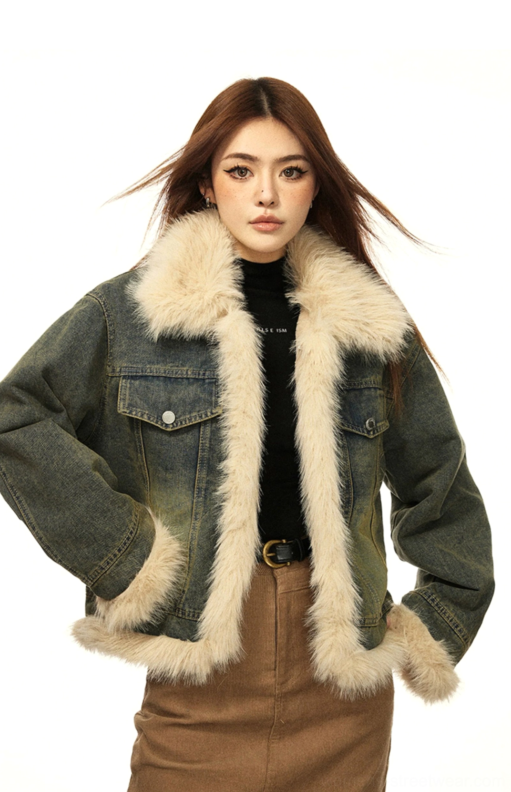 Side three-quarter view of a relaxed cropped faux fur lined denim jacket styled with a brown midi skirt for vintage streetwear