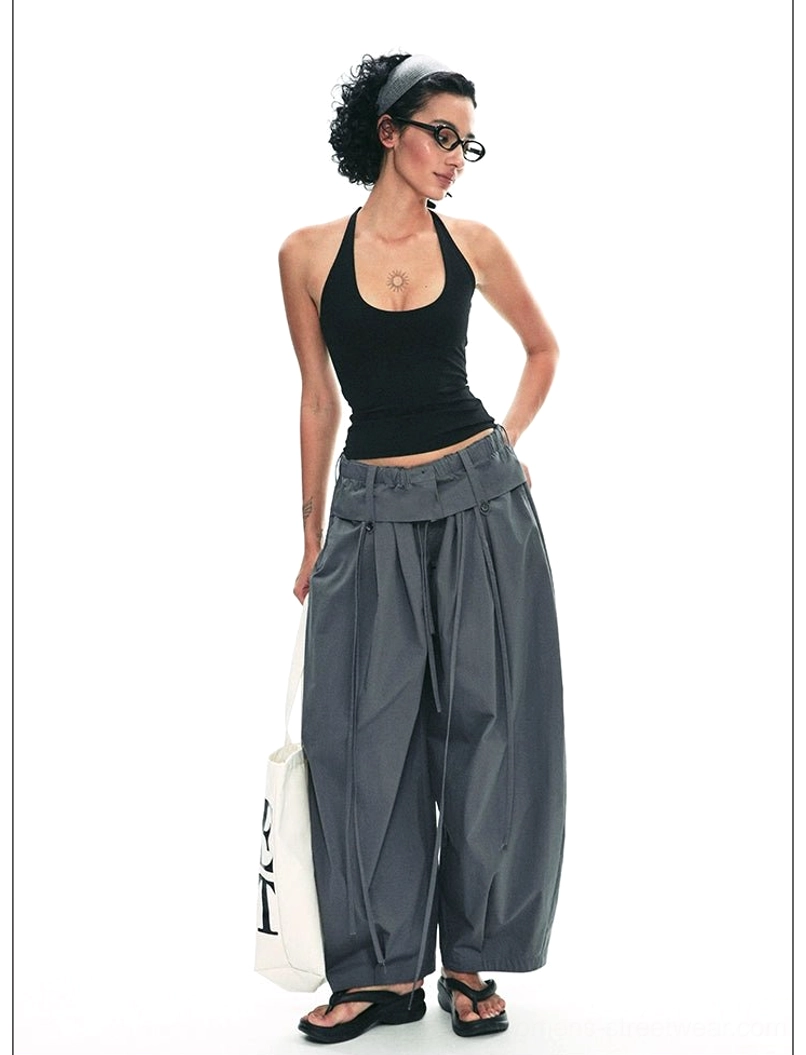 Dark gray relaxed paperbag wide-leg streetwear trousers back three-quarter view showing clean loose tailored fit