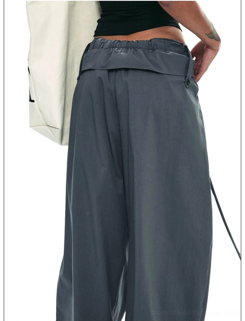Dark gray relaxed drawstring paperbag trousers back waist close-up showing elastic fold-over detail and wide-leg fit