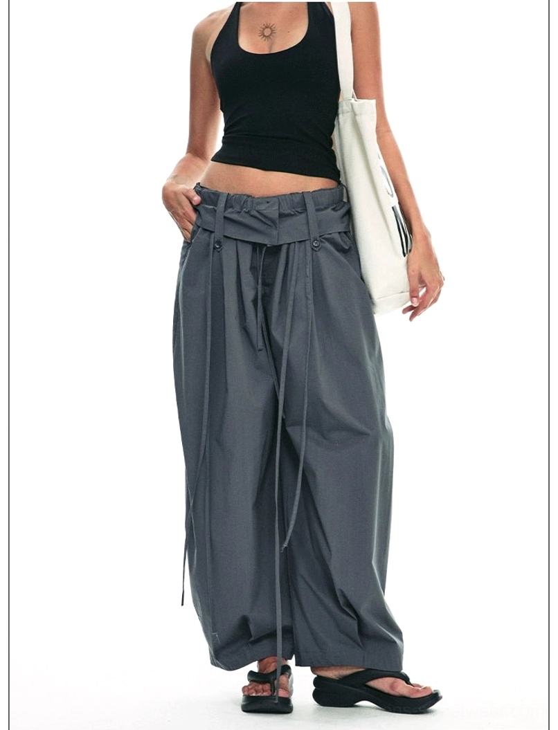Dark gray full-length paperbag wide-leg trousers side view highlighting relaxed drape drawstring waist and loose leg cut