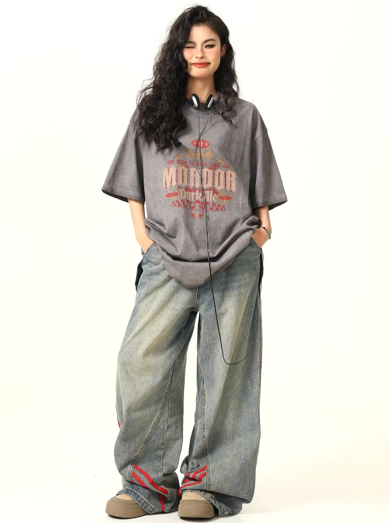 Relaxed front view of a woman wearing a faded gray MORDOR fantasy graphic oversized T-shirt with loose casual streetwear styling