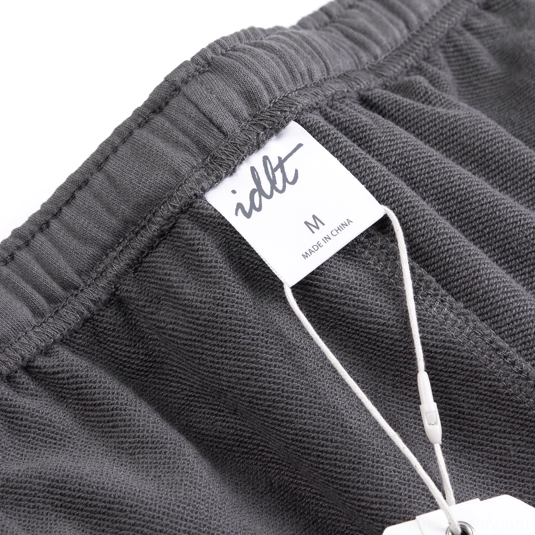 Close-up interior view of relaxed fit French terry shorts showing soft brushed lining, size label and garment construction