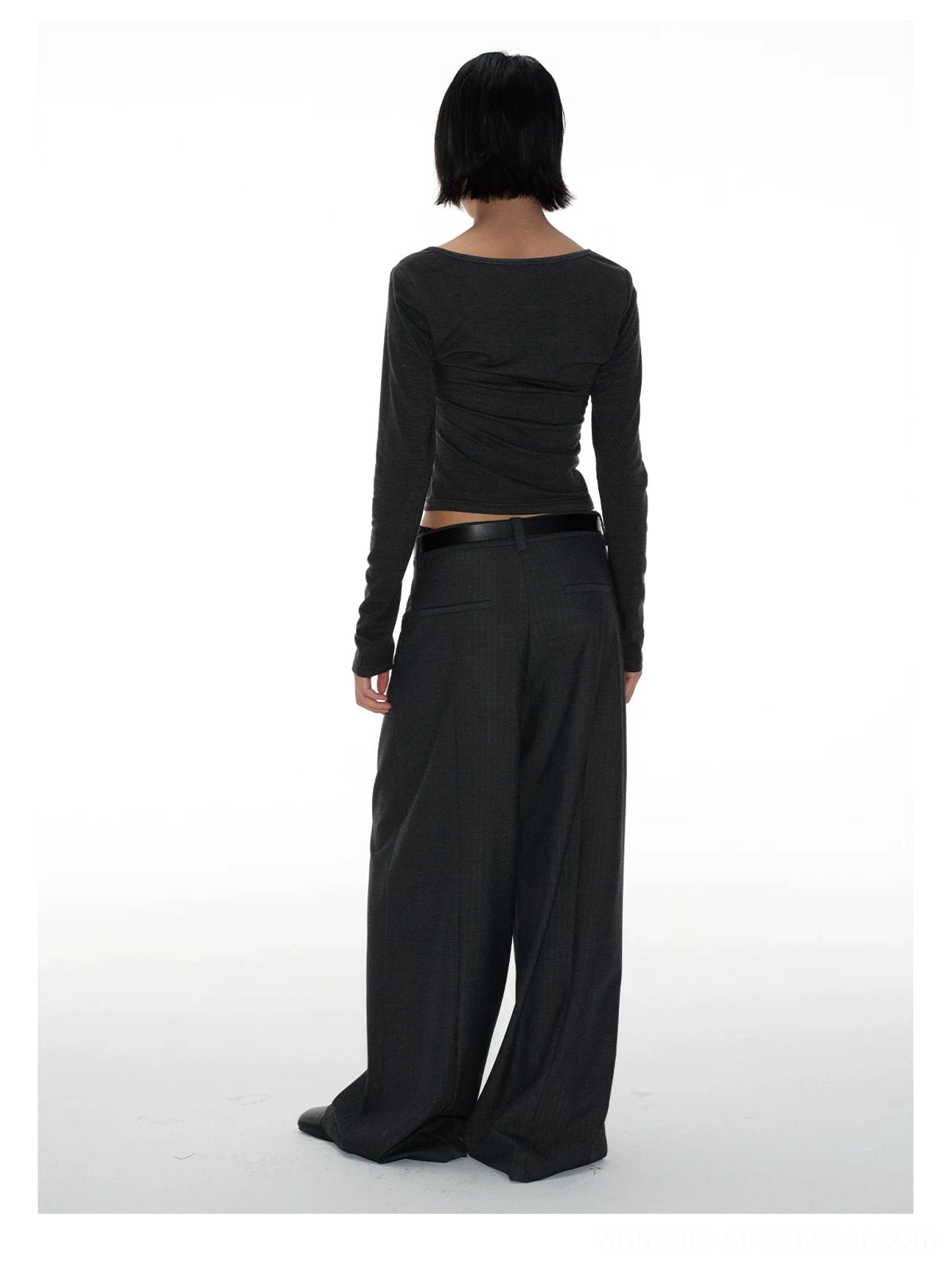 Full back view of relaxed floor-length wide-leg tailored pants with a clean waistband, belt loops, and minimalist streetwear styling