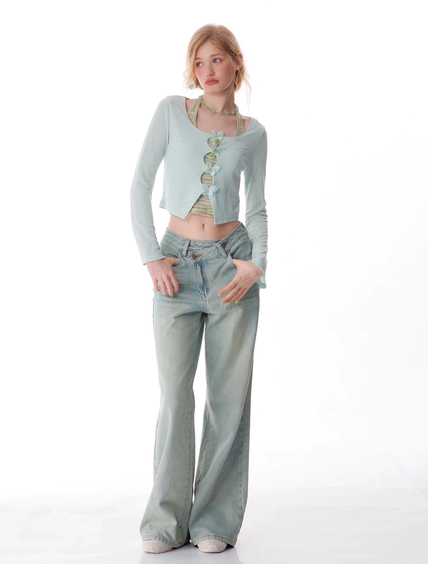 Relaxed women's light wash wide leg denim jeans with slanted waistband and vintage streetwear silhouette