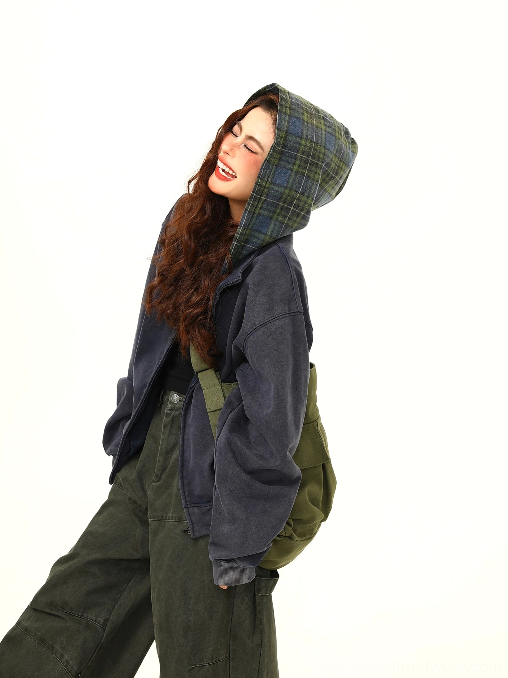Three-quarter view of a relaxed oversized hooded zip jacket showing the plaid-lined hood and soft draped fit