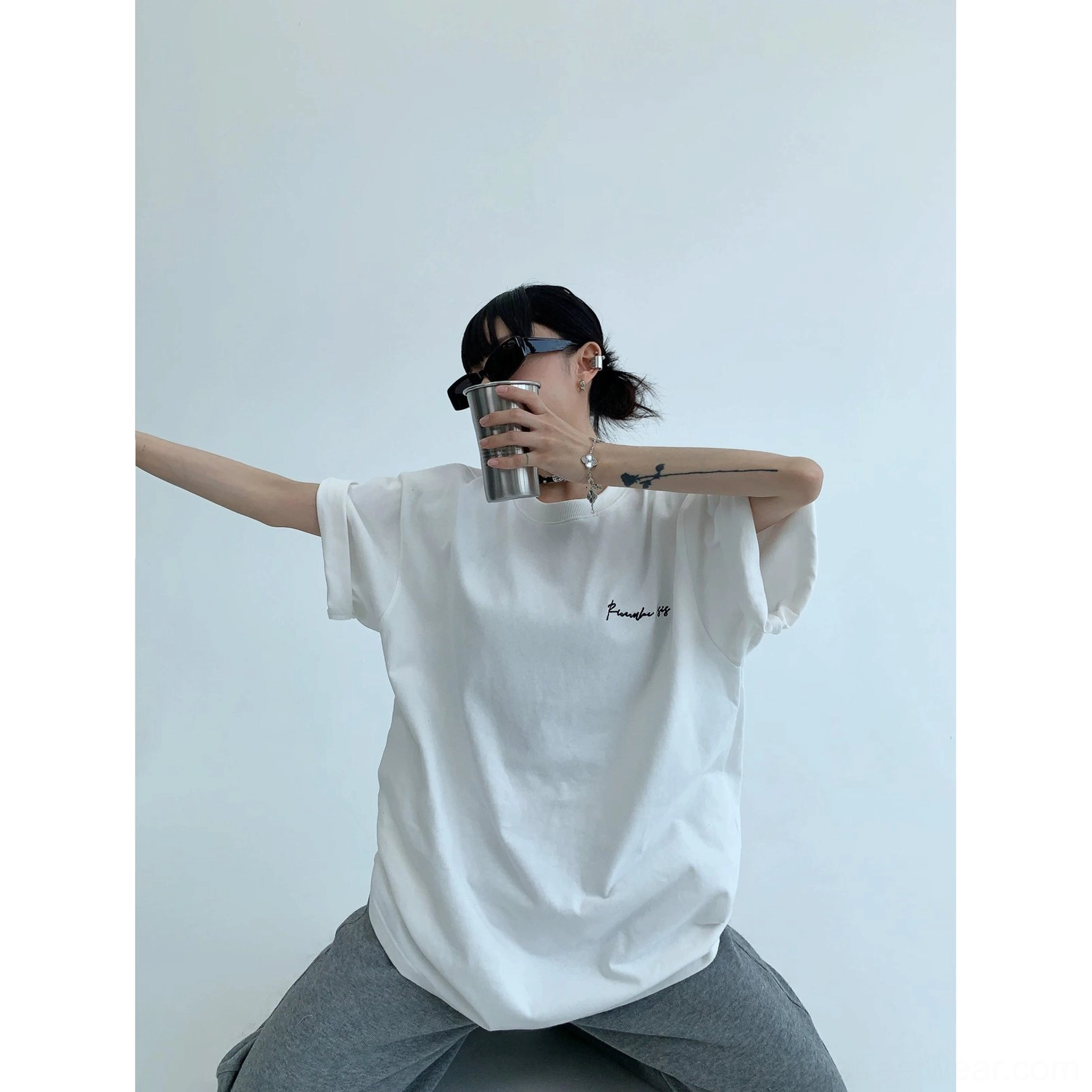 Relaxed oversized graphic tee with neon pink script lettering, heavyweight cotton jersey, and contemporary Korean streetwear influence