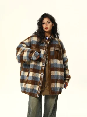 Relaxed oversized plaid shacket with button front closure leather trimmed chest pockets and drop shoulder sleeves