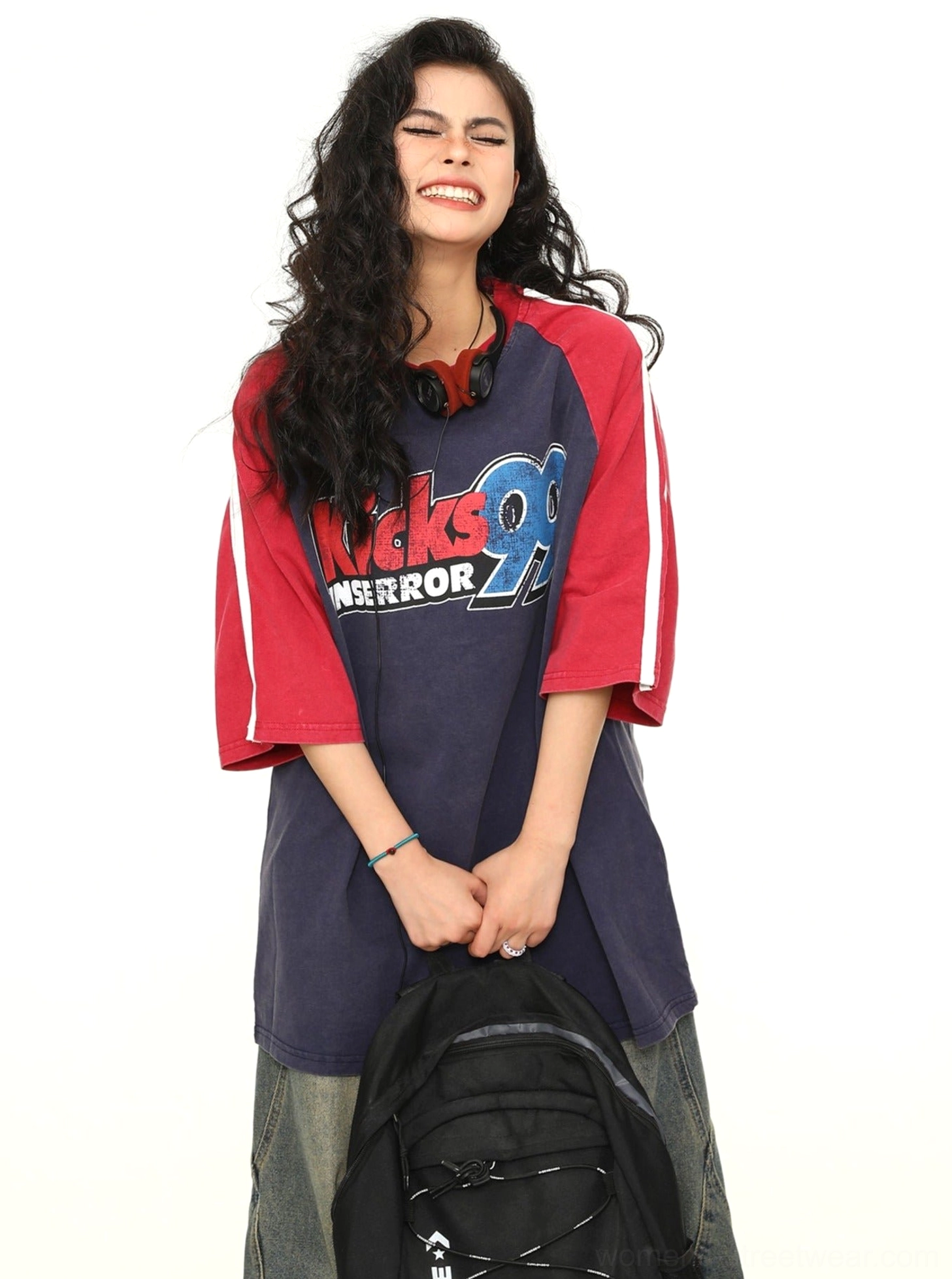 Front view of a relaxed oversized varsity baseball T-shirt featuring a navy body, red sleeves, and retro graphic print