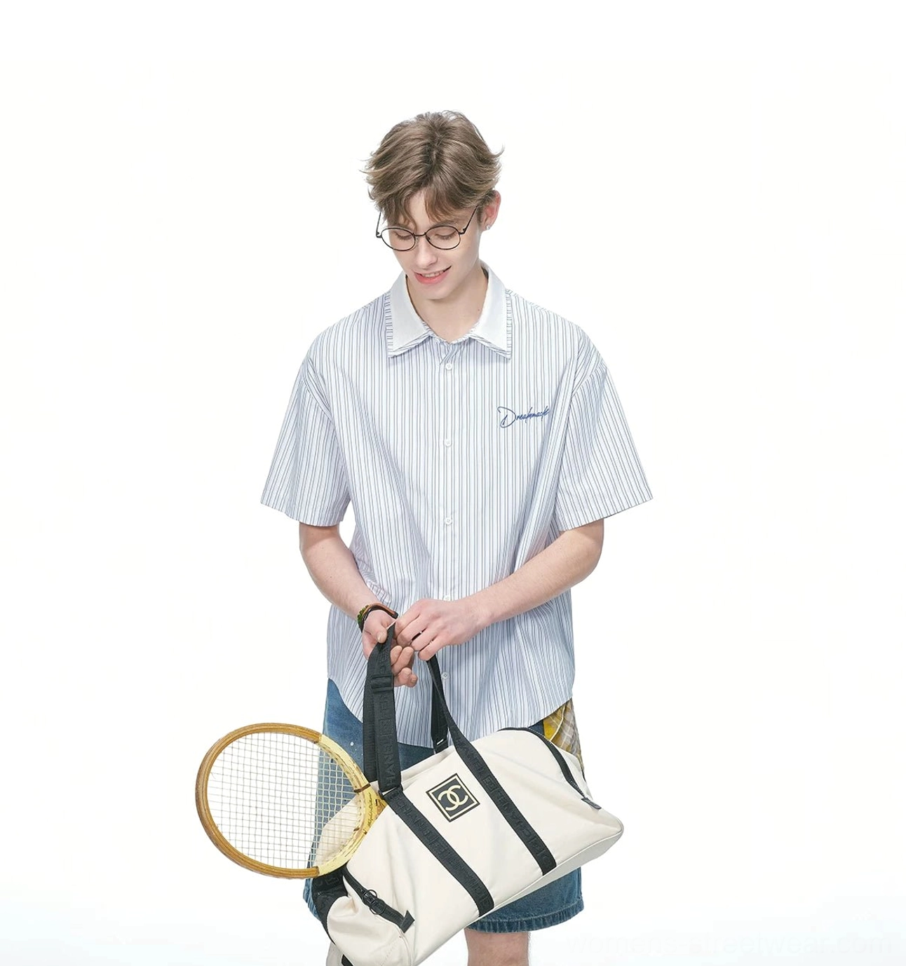 Relaxed pinstripe short sleeve button down streetwear shirt with vertical stripes and embroidered chest detail styled with denim shorts