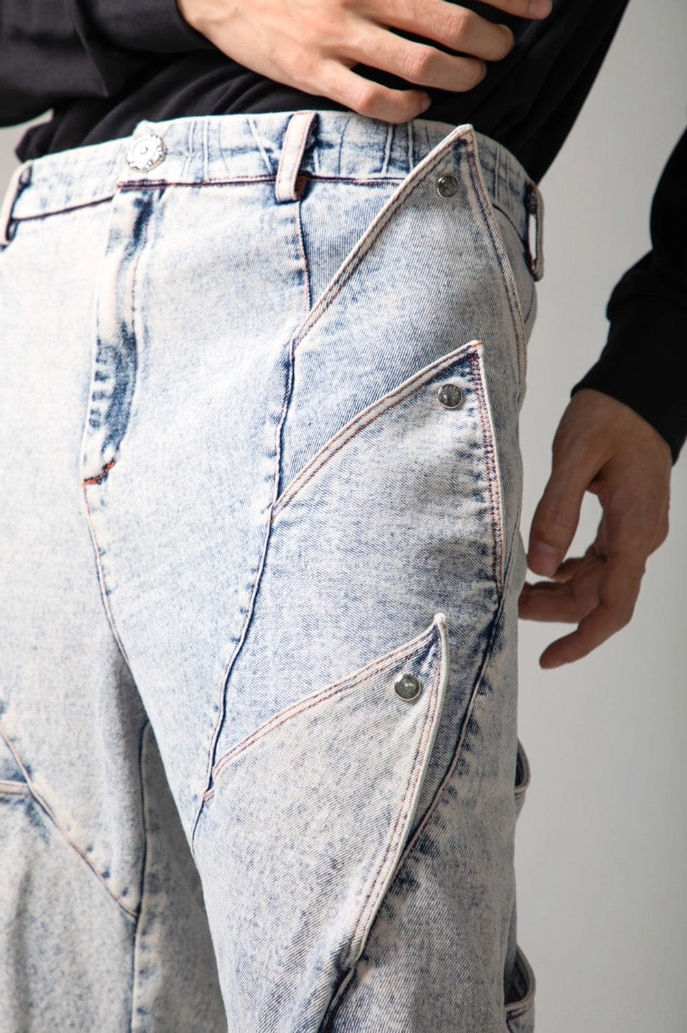 Relaxed shark fin baggy jeans featuring layered leg panels, wide proportions, and distinctive streetwear denim styling