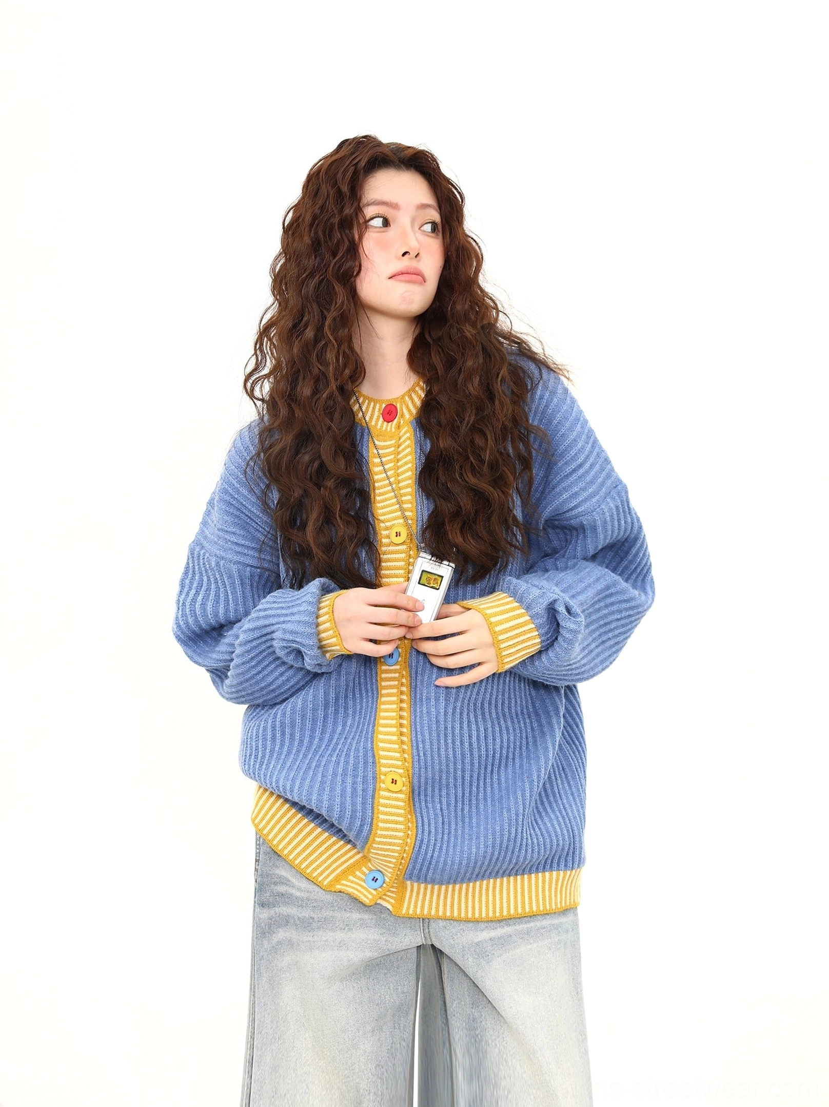 Three quarter front view of relaxed sky blue ribbed cardigan featuring yellow collar and cuff trims