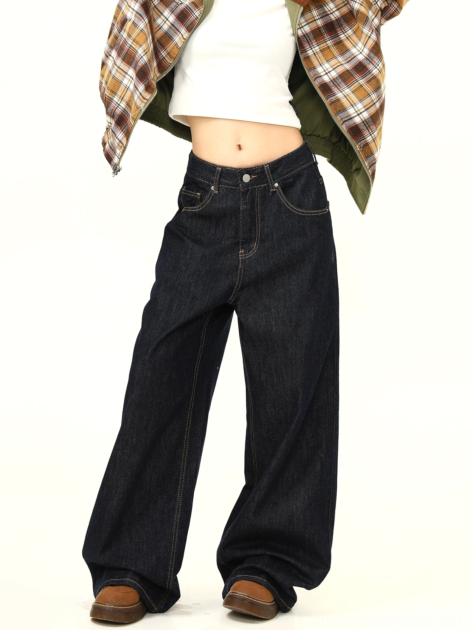 Angled front view of women wearing relaxed ultra wide leg black jeans with contrast topstitching and drapey denim